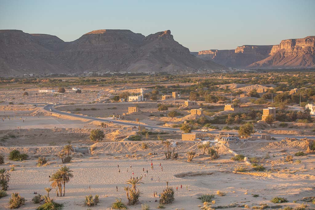 Men and boys playing soccer in the field Shibam, Wadi Hadhramaut, Hadhramaut, Yemen